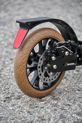 The rear wheel of the scooter has a disc and foot brake.