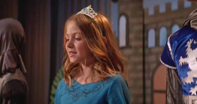 School play depicting medieval times with children in costumes on stage