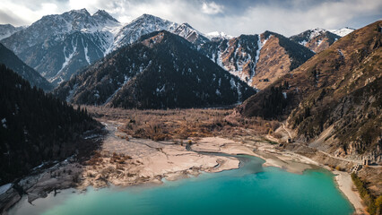 Obraz premium Horizontal landscape drone view on lake and mountain snow peaks