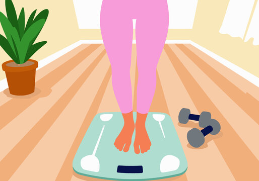 Woman standing on weighing scale at home