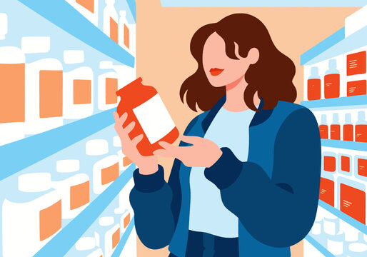 Woman reading label of supplement bottle at supermarket