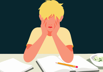 Worried boy sitting at desk with notebook and pencil