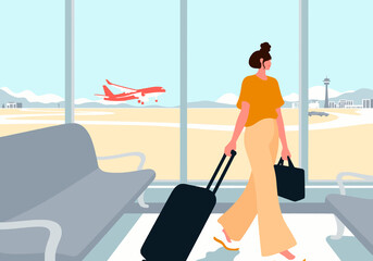 Businesswoman with suitcase walking in airport terminal