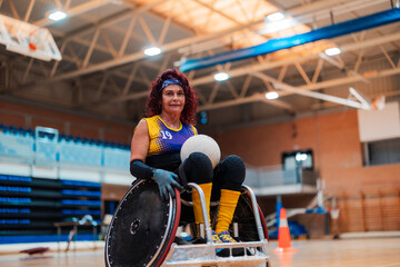 Smiling mature disabled rugby player sitting with ball in wheelchair at sports court