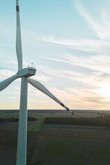 Green energy wind turbine at sunset