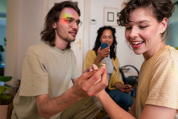 Man showing engagement ring to woman at home