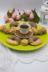 Coffee with Cookies and Almonds on Green Plate