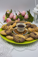 Chocolate-Dipped Cookies and Coffee on Green Plate