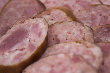 Assorted smoked meats with rich pink hues and marbled textures