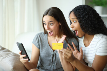 Amazed interracial buyers paying online