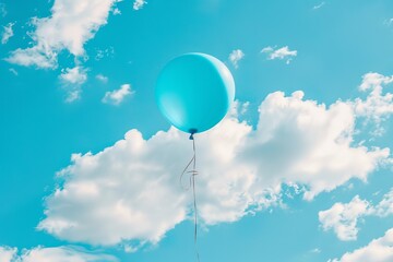 Obraz premium Bright blue balloon floating in clear sky with fluffy white clouds. Concept of blue Monday