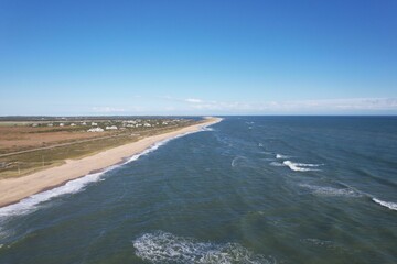 Aerial view of a scenic coastline with a sandy beach.