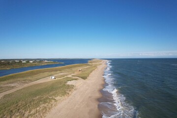 Aerial view of a beautiful sandy beach with waves.