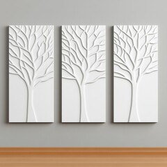 Obraz premium Three white panels featuring tree branch designs on a gray wall.