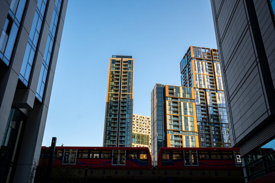A vibrant image capturing modern residential towers set against a clear blue sky, showcasing the harmonious blend of urban living and architectural progress  in London UK