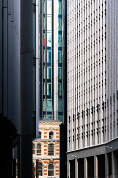 A captivating view of an alleyway juxtaposing contrasting architectural styles, with sleek modern architecture next to historic facades, emphasizing urban transformation  in London UK