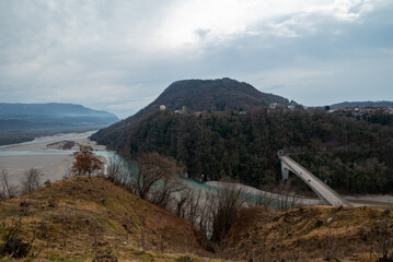 The bridge and the road to Pinzano in Friuli, and the Tagliamento river. We are close to the germanic shrine in a foggy morning of winter with dry soil and vegetation