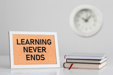 Learning Never Ends is shown using the text and photo of the books and clock