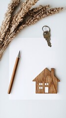 A minimalist setup of a mortgage approval document with a pen and keychain in the shape of a house, leaving ample copy space for text.