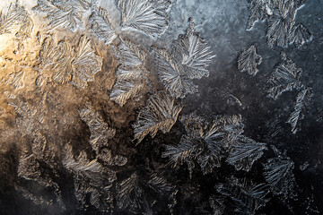 Close-Up of Winter Frost Patterns and Ice Crystals on Glass: Chilling Cold Weather Background