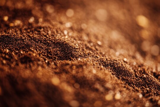 A detailed close-up of the texture of dark, rich soil with fine granules, highlighting the complexity and nurturing aspect of natural earth material.