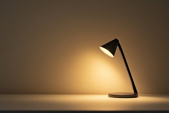 A dark desk lamp on a white tabletop emits a warm glow, creating a cozy, tranquil atmosphere, perfect for reading or studying in a serene environment.