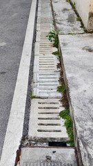 Obraz premium sewer drainage grate, a row of stone sewer grates