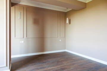 A room with a white wall and wooden floor