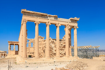 The building is a temple with columns and a large open doorway, Acropolis in Athens