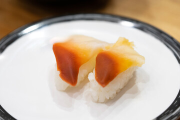 Japanese Stimpson surf clam or hokkigai sushi on white plate. 
