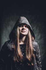 Hooded Woman in Dramatic Portrait with Intense Expression