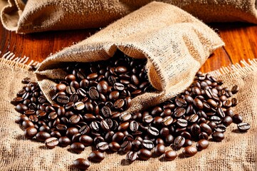 A bag of coffee beans is sitting on a wooden table