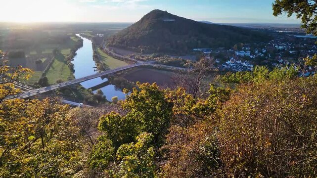 View from the Porta-Kanzel reveals the Kaiser Wilhelm Monument at Porta Westfalica, perched on a hill above the winding Weser River.