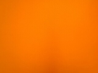Wall painted in bright and warm orange tone for background and decorations