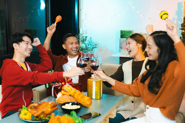 drinks and conversation, social gathering and get together at New Year young people, group and gift exchange at the event, celebration at home.