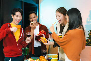 drinks and conversation, social gathering and get together at New Year young people, group and gift exchange at the event, celebration at home.