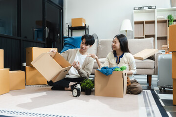 young couple helps put things in boxes and prepares to move to a new house.