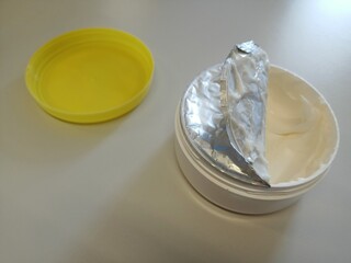 Hand cream, box, opened, on the table.