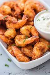 Crispy golden fried shrimp served with a savory dipping sauce perfect for appetizers at a coastal restaurant