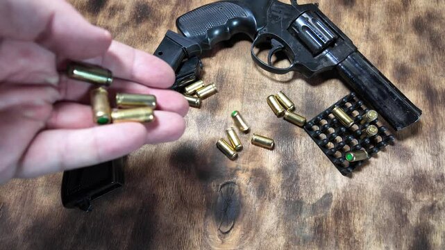 gun cartridges slow motion video. Cartridges falling on table slow motion video. Shot. Gun. Self-defense. Danger.