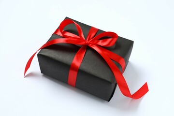 Beautiful gift box tied with bow on white background 