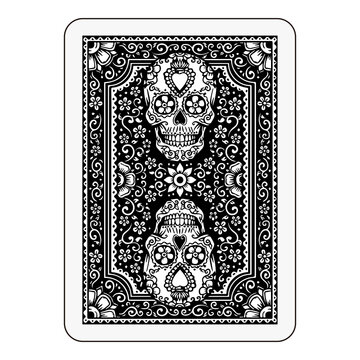 Back of playing card with ornate black skull pattern, intricate decorative border.

