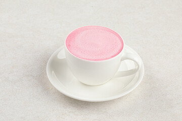 Cup of deliicous pink cappuccino coffee drink