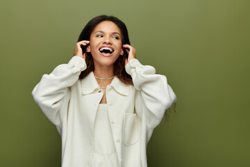 The woman expresses delight, radiating happiness while surrounded by a calming green hue.