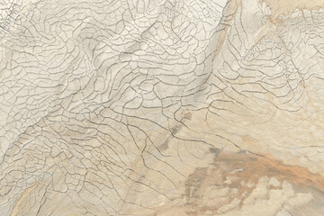 Cracked mud texture in natural earthen tones