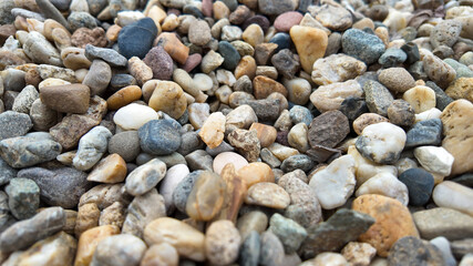 A close-up of colorful pebbles, highlighting natural texture, makes a perfect background for concepts of tranquility and outdoor exploration