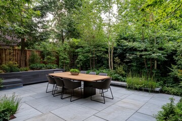 Obraz premium This image captures a modern patio dining area surrounded by dense, lush greenery, featuring a sleek wooden table and eight contemporary chairs on stone tiles.