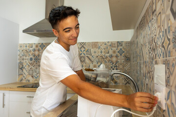 Trans man happily performs tasks in new kitchen