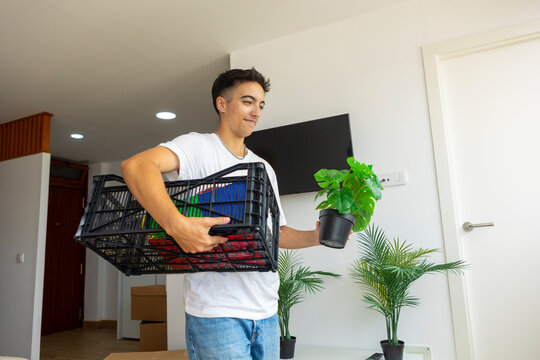 Trans man unpacking belongings in new home
