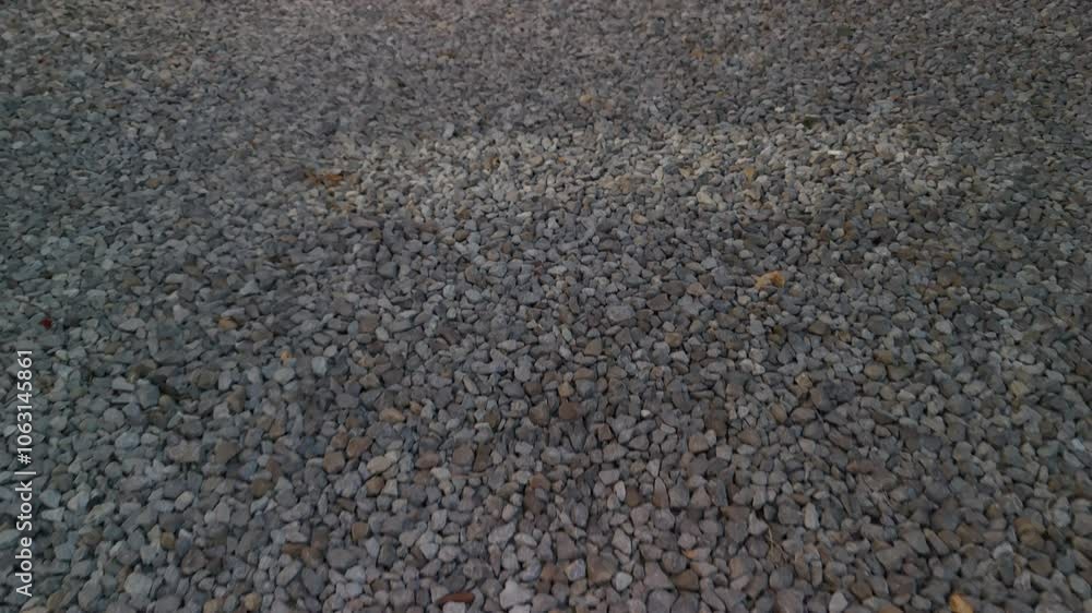 Poster close-up of small, textured pebbles on the ground, creating an intriguing and natural surface. ideal